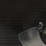 Dark horizontal tile flooring with modern chair