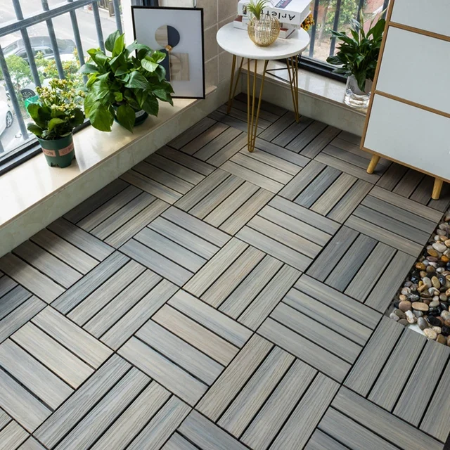 Interlocking grey wood-look decking tiles on a balcony.